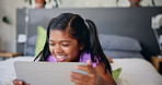 Relax, happy and kid on tablet on bed for online entertainment, watching cartoons and movies. Family home, laughing and young girl on digital tech for streaming videos or playing games in bedroom