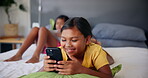 Laughing, watching and child with smartphone, home and online for funny videos, social media and happy. Bedroom, streaming and girl with mobile for movies, digital and kid with tech for entertainment