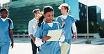 City, medical student and tablet with girl walking outdoor for agenda, education or schedule. Healthcare, medicine and university with group of people downtown for travel to clinic or hospital