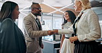 Handshake, meeting and smile with business people in lobby of office together for agreement or welcome. B2B, deal and partnership with happy employee group shaking hands in convention center