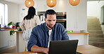 Entrepreneur, man and typing on laptop in home for article research, proofreading online blog or creative process. Remote work, writer and editing story in kitchen with family and manuscript feedback