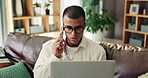Home, man and laptop with phone call for communication, networking and customer enquiry on sofa. House, male person and talking with mobile for banking service, technical support and digital finance