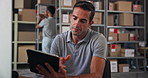 Tablet, supply chain and man in warehouse for distribution stock with cardboard boxes on shelf. Digital technology, packages and male delivery coordinator checking online order for ecommerce parcel.