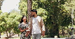 Walking, holding hands and kiss with couple in park for romance, love and care. Summer date, honeymoon and relationship with man and woman bonding in nature for support, trust and happiness together