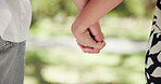 Romance, holding hands and closeup with couple in park for love, affection and care. Summer date, honeymoon and relationship with man and woman bonding in nature for support, trust and happiness