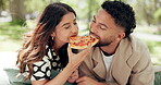Eating, couple and relax with pizza at park for romantic date, meal sharing and bonding together. Hungry, happy people and fast food lunch in nature for love, conversation and relationship support