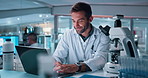 Smile, man and scientist on laptop in lab of vaccine research, experiment results and treatment. Male person, study and digital for biotechnology, investigation feedback and healthcare report of cure