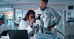 Smile, people and scientist with microscope in lab of research, study bacteria and medical experiment. Staff, biotechnology and tablet for testing sample, virus growth and pharmaceutical breakthrough