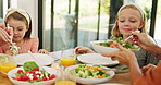 Children, happy and family lunch with food, helping hand and plate for salad, bonding and love at Easter. Girl, kids and or for nutrition, health and diet with care for holiday with thanks in home