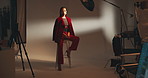 Photography, set and model on stool in studio with production team for creative magazine. Fashion, equipment and gen z female influencer posing on chair for portfolio photoshoot with art agency.