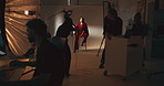 Photography, woman and model on stool on set in studio with production team for creative magazine. Fashion, equipment and female influencer posing on chair for portfolio photoshoot with art agency.