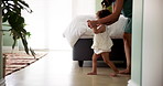 Home, walking and mother with baby, celebration and bonding together with happiness. First steps, mama and balance with toddler, kid and child development with growth, motor skills and learning
