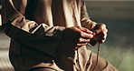 Home, praying and hands of Muslim man with beads for religious belief, worship and praise to Allah. Religion, spiritual and person with misbaha for prayer, salaah and fasting for Ramadan Kareem