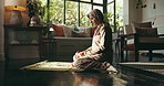 Fasting, prayer and Muslim woman in home for religion, worship and praise Allah in living room. Religious belief, spiritual and Islamic person on mat for Ramadan Kareem, salaah and praying for faith