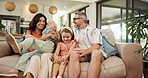 Parents, child and playful with hug on sofa with care, love and bonding in living room at family home. People, mother and father with kids, girl and excited with game, embrace and happy in house