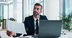 Document, laptop and businessman in office with finance report for online company profit budget. Reading, computer and male financial manager with paperwork for investment revenue in workplace.