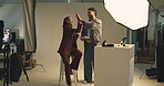 Photography, laptop and high five with people in studio for campaign photoshoot, editor and success. Production planning, support and model with man and tablet on set for backstage, approval and idea