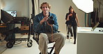 Camera, photography and talking with man on set for fashion magazine or style photoshoot. Direction, instruction or production with photographer behind the scenes for artistic or creative catalog