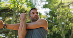Outdoor, athlete and man with earphones, stretching and listening to music for fitness and serious. Routine, training and warm up for person in nature, performance or workout with playlist in morning