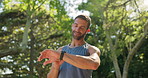 Fitness watch, running and man in nature for race, marathon or challenge training with time. Exercise, sports and male runner athlete with health wristband for cardio workout outdoor in park.