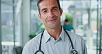 Face, doctor and happy man in clinic for healthcare service, medicine and wellness. Medical professional, cardiologist and portrait of worker, coworking and confidence with experience in hospital