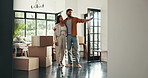 Planning, ideas and couple with boxes in new home for property, moving and interior design. Homeowner, real estate and happy man and woman hug and talking with mortgage, house purchase and apartment