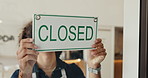 Man, cafe and closed sign on door, small business and storefront or end of service message. Display, professional person and information to customer on poster, coffee shop and notice for hospitality