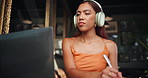 Woman, student and laptop with writing at coffee shop, headphones and notes for virtual class in morning. Girl, person and e learning with computer, study or review for education with sound at cafe