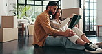 Boxes, tablet and couple on floor, conversation and relax in living room with new property. People, apartment and man with woman, tech and digital app for real estate, love and renovation in lounge
