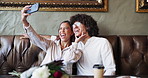 Selfie, laugh and couple in restaurant for love, romance or anniversary celebration together. Photograph, smile and bonding with man, woman and flowers for valentines day date joke for social media