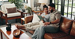 Couple, tablet and talk on couch in home, relax and embrace with planning vacation in living room. Man, woman and digital touchscreen with app, happy and search for holiday location on social media