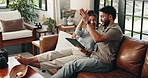 Couple, tablet and high five on sofa in home, success and trading with profit in living room. Man, woman and digital touchscreen on application, happy and celebration with goals for financial freedom