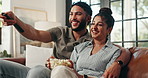 Playful, TV and couple relax on sofa for watching movies, film or series on streaming subscription in home. Love, happy and man with woman on couch for entertainment, bonding or videos in living room