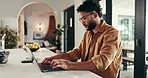 Laptop, typing and man in home office for accounting, remote work or review revenue document. Computer, freelance auditor and financial report online, reading and bookkeeping with profit or serious