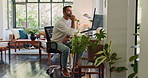 Computer, creative and thinking with man in home office for remote work or startup business. Administration, coffee and writing with freelance employee in apartment for idea, planning or proposal