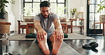 Man, fitness and stretching in home for warm up, workout exercise or training for leg muscle. Endurance, goal and athlete person for cardio, wellness and balance on floor with mat for challenge