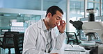 Laboratory, science and man with headache on computer for research, medical study and microscope for sample. Healthcare, pharmaceutical and scientist with fatigue, burnout and stress for mistake