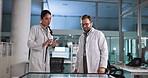 Scientist, research or discussion with tablet in lab for pharmaceutical review, medical comparison or innovation. Night, people or interactive display for studying science data, teamwork and results