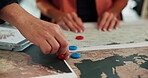 Hands, people and pin on map in office of target location, global selection and planning of project. Staff, explain and choice for turbine production, wind resource and geographical chart of landmark
