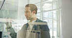 Man, writing and sticky note on window for planning, strategy and workflow timeline in office. Business person, thinking and ideas on glass for company development, brainstorming and to do list