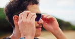 Exercise, sunglasses and face of man in nature ready to start workout, training and fitness for marathon. Sports, eye protection and person with frames for wellness, health and challenge outdoors