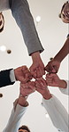 Fist bump, below and hands of business people in circle for teamwork, collaboration and partnership. Professional office, corporate diversity and men and women for connection, support and solidarity