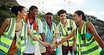 Community, volunteering or people in huddle on beach for cleaning, conservation or environmental activism. Group, helping or happy friends on seaside coast for charity service, achievement or success