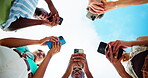 Outdoor, group and people with hands for smartphone, typing and connection for social media in circle. Blue sky, friends and network with mobile for application, digital and technology in low angle
