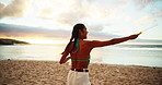 Beach, vacation and woman blow bubbles on adventure, travel or game on island at sunset. Girl, sea and play with soap outdoor for fun, happiness or spinning for freedom at ocean on summer holiday