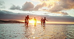 Water, relax and friends on beach at sunset for holiday, vacation and weekend together. Nature, travel and back of men and women in ocean, sea and waves for adventure, freedom and bonding outdoors