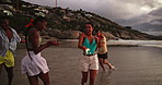 Beach, dancing and friends with vacation, sparklers and celebration with tropical island. Happy people, seaside and group with party, fireworks or summer holiday with social event, travel or Zanzibar