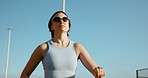 Running, fitness and woman in city, cardio and exercise goals with energy, training and sunglasses. Person, runner and athlete with challenge, practice and shades with workout, health and wellness