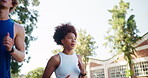 Running, exercise and interracial couple in town for cardio, workout and marathon training. Low angle, fitness and young man with woman for endurance, love and health with runner on road with energy