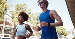 Running, fitness and interracial couple in town for cardio, exercise and marathon training. Low angle, workout and young man with woman for endurance, love and health with runner on road with energy